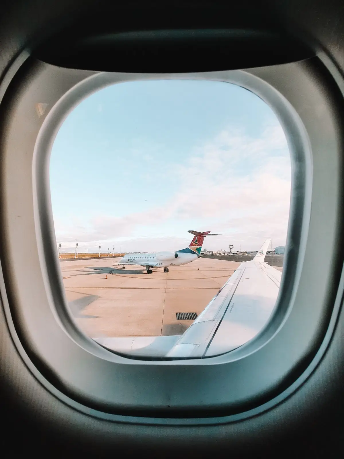 An aircraft on the tarmac seen through a cabin window