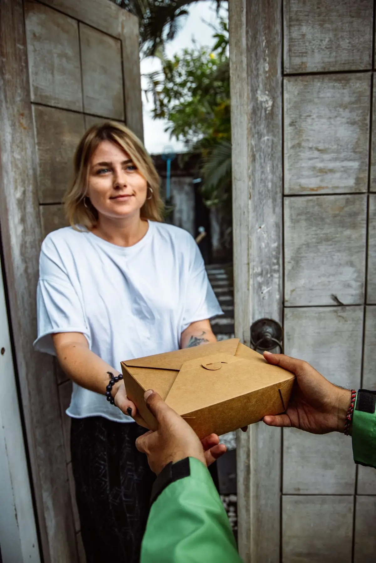 A parcel being handed over on a doorstep