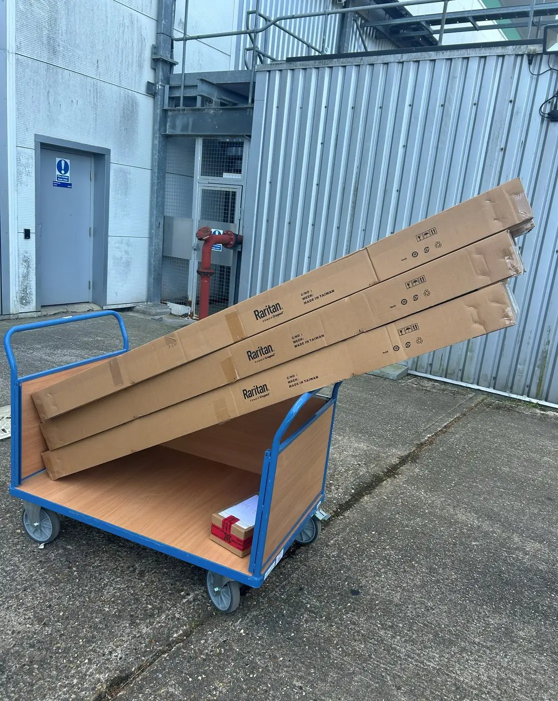Boxed equipment on a trolley at a loading bay