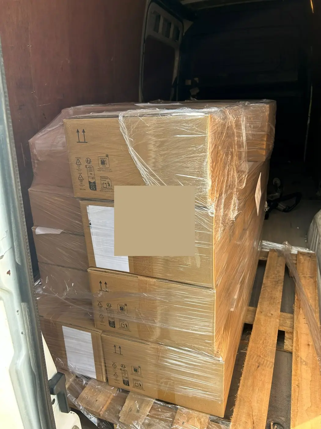 A wrapped pallet loaded in the back of a van