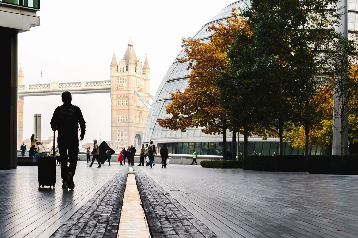 A traveller with a suitcase near Tower Bridge